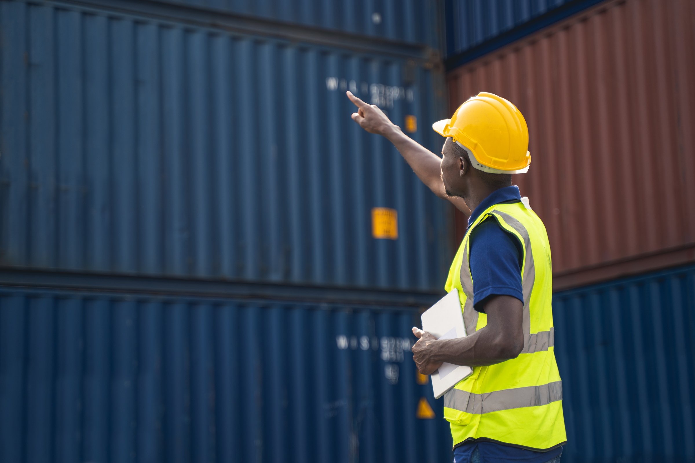 Worker Checking Cargo Containers